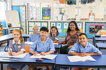 Photo of a teacher and students in a class room