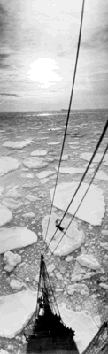 This photograph was taken by the light of the midnight sun, shows the bow of the "Discovery" wending a way through floes and brash ice off the coast of Kemp Land. Antartica, 1929–31 – Frank Hurley, courtesy National Library of Australia.