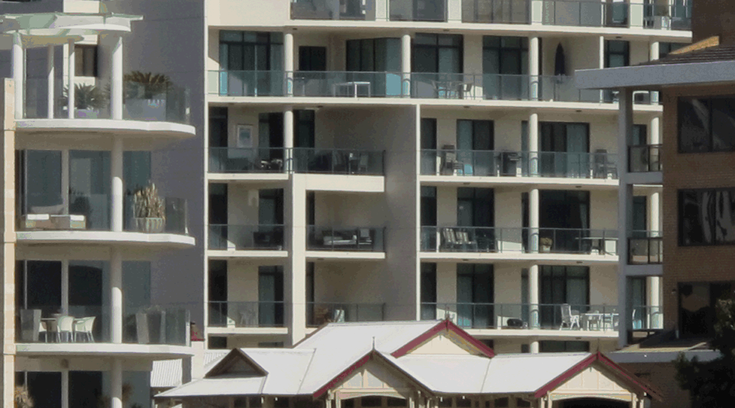 3 houses made of $100 notes