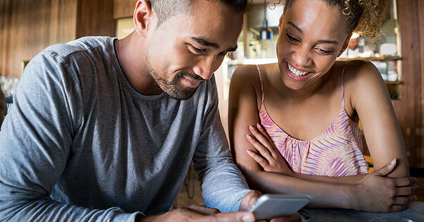 Young couple looking at phone together